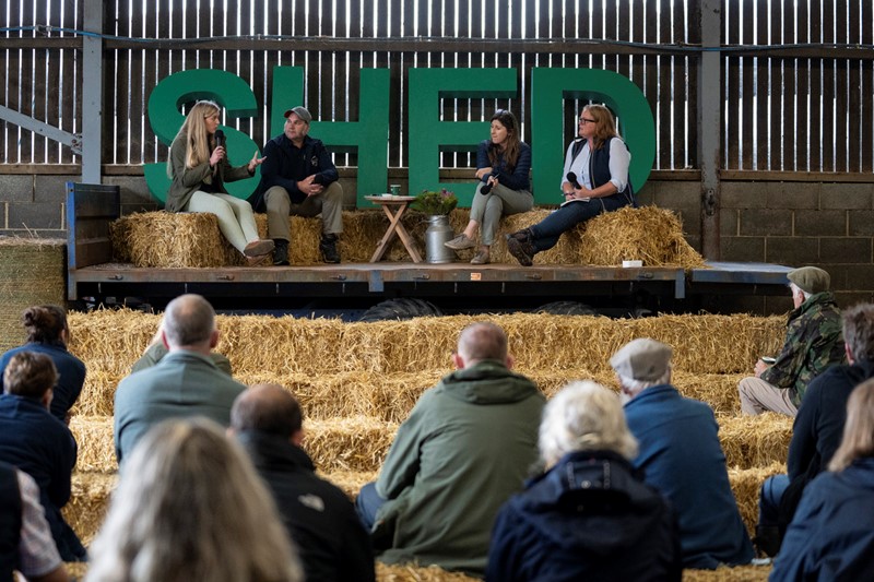 Panellists sat on hay bales facing audience of farmers