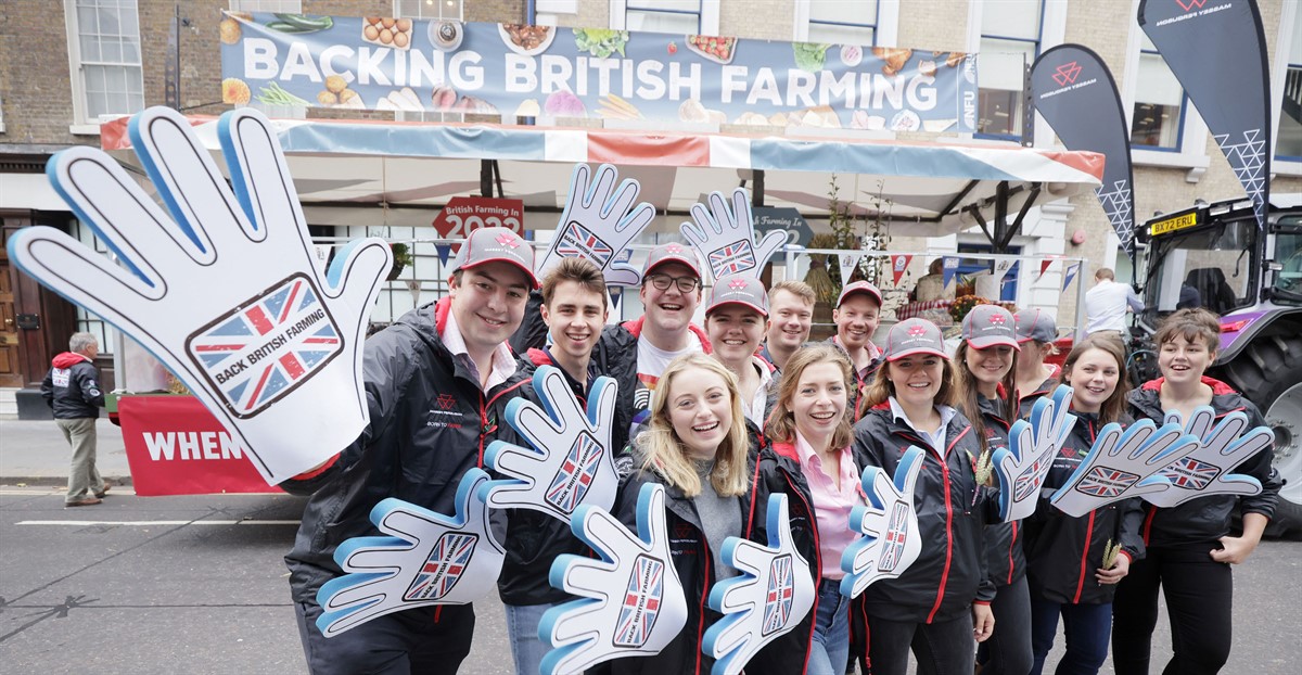 NFU student ambassadors waving back british farming signs