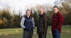 Three farmers smiling to the camera