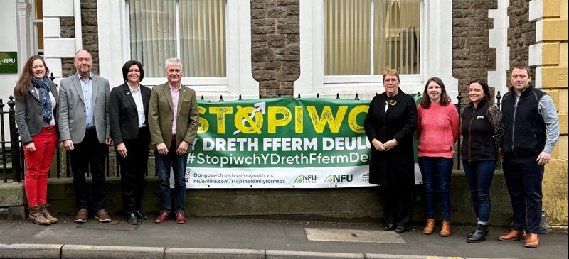 Group of people having photo in front of banner