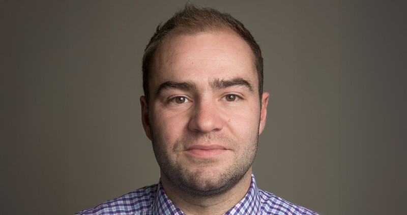 A man wearing a blue striped shirt