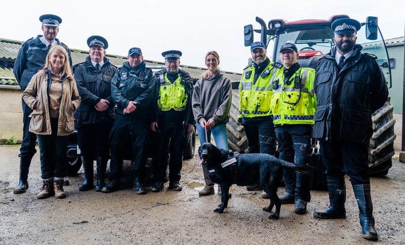 Police and the Police and Crime Commissioner standing in front of a tractor