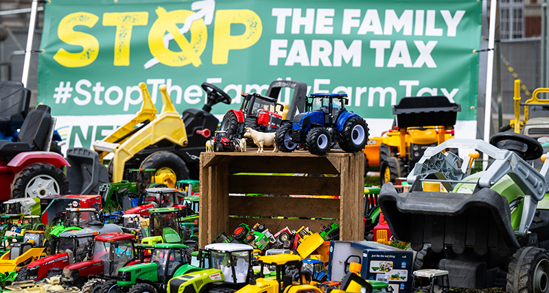 Toy tractors on a crate in pre-loved farm toy display